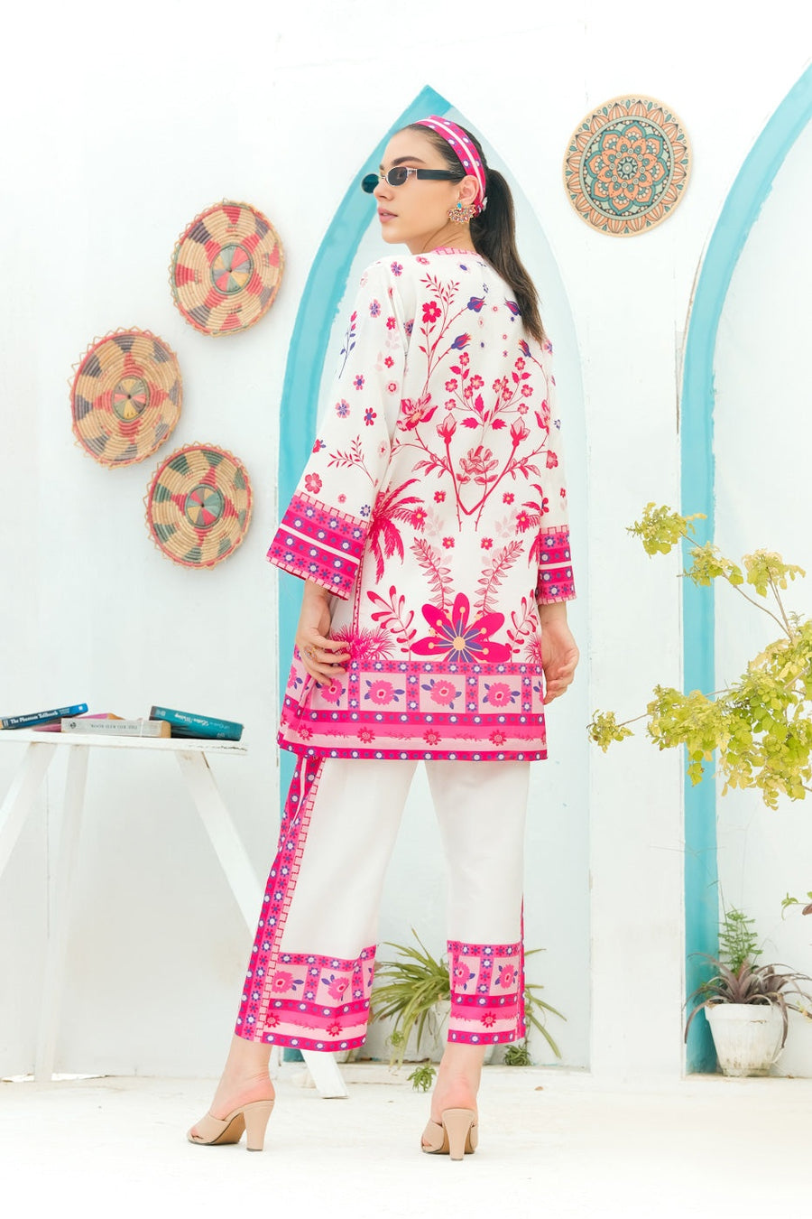 Woman wearing a pink and white Printed Co-ord set-back-pose